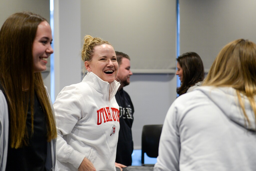 (Chris Samuels | The Salt Lake Tribune) Utah women’s basketball head coach Lynne Roberts, center, and the team reacts after learning where and who they will play in the NCAA women’s college basketball tournament at the team’s practice facility, Sunday, March 13, 2022.
