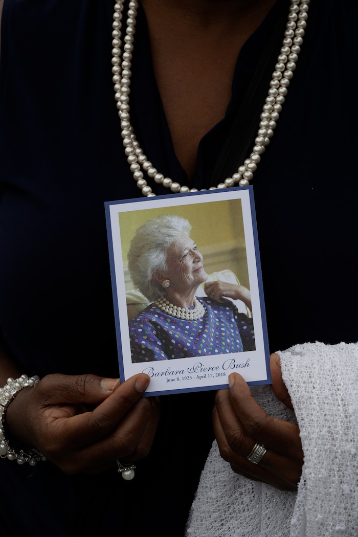 Dorothy Hanson holds the program as she leaves the visitation of former first lady Barbara Bush at St. Martin's Episcopal Church Friday, April 20, 2018, in Houston. Barbara Bush died on April 17, at the age of 92. (AP Photo/David J. Phillip )
