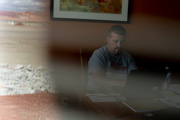 Scott Nargis, a U.S. Army veteran and incident commander with Team Rubicon, works in his housing at the Kayenta Health Center on the Navajo reservation in Kayenta, Ariz. on April 18, 2020. The Navajo reservation has some of the highest rates of coronavirus in the country. Team Rubicon is helping with medical operations as cases of COVID-19 surge. (AP Photo/Carolyn Kaster)