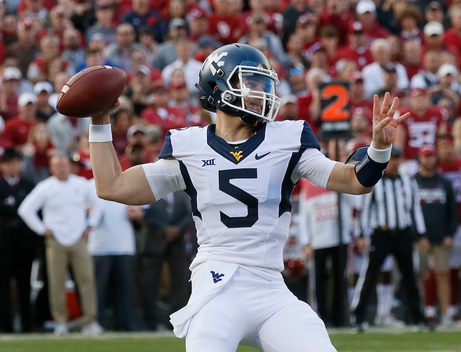 West Virginia quarterback Chris Chugunov (5) passes in the second quarter of an NCAA college football game against Oklahoma in Norman, Okla., Saturday, Nov. 25, 2017. (AP Photo/Sue Ogrocki)