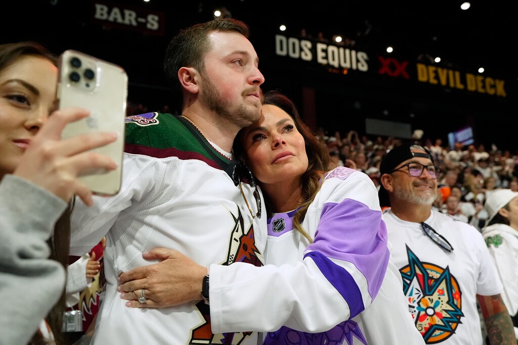 (Ross D. Franklin | AP) Arizona Coyotes season-ticket holders comfort one another as time expires in the team's game against the Edmonton Oilers on Wednesday in Tempe, Ariz., Wednesday, April 17, 2024. The Coyotes won 5-2. Coyotes owner Alex Meruelo agreed to sell the franchise's hockey operations to Utah Jazz owner Ryan Smith, who intends to move the team to Salt Lake City.