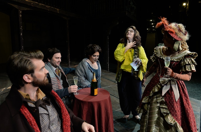 (Francisco Kjolseth  |  The Salt Lake Tribune)  Director Kathleen Clawson, center right, exclaims "Opa! for good luck," as she dabs some spilled drink on her neck as Utah Opera's season opener, "La bohème," Puccini's popular tearjerker about starving artists in turn-of-the-century Paris, sets up scenes for a photo shoot. On set were: Michael Adams (Marcello), Scott Quinn (Rodolfo), Jennifer Black (Mimì),  and Celena Shafer (Musetta), from left.