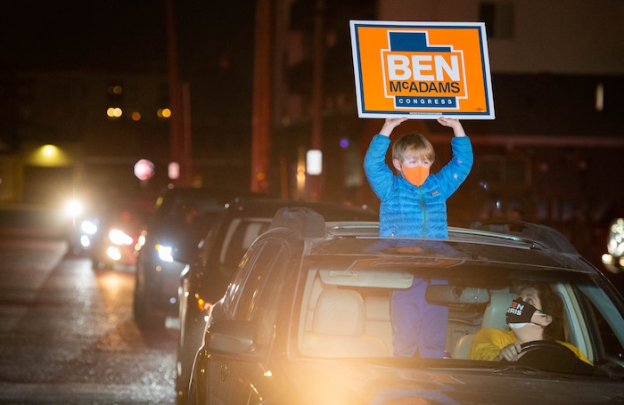 (Francisco Kjolseth  |  The Salt Lake Tribune) Oliver Conger, 7, and his mom Helen Langan show their support for Democratic Rep. Ben McAdams, looking to retain his seat for Utah’s 4th Congressional District, as he hands out pre-ordered meals to friends and supporters driving up to Pat’s BBQ in Salt Lake City, as part of his small election night watch party on Tuesday, Nov. 3, 2020.