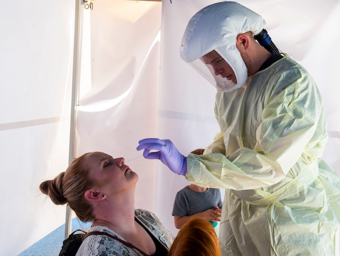 (Rick Egan  |  The Salt Lake Tribune)   Cassie Neeley gets tested by Intermountain Healthcare medical assistant, Connor Meads, at the Intermountain Healthcare Coronavirus Mobile Testing Unit at Utah Valley Hospital in Provo, Friday May 8, 2020.