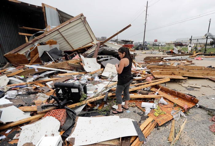 (David J. Phillip  |  AP Photo) Jennifer Bryant looks over the debris from her family business destroyed by Hurricane Harvey Saturday, Aug. 26, 2017, in Katy, Texas.   Harvey rolled over the Texas Gulf Coast on Saturday, smashing homes and businesses and lashing the shore with wind and rain so intense that drivers were forced off the road because they could not see in front of them.
