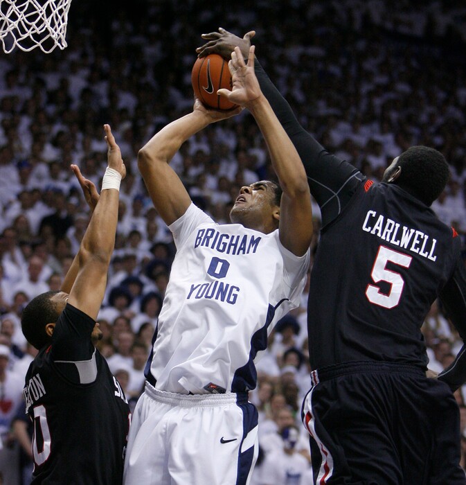 (Steve Griffin | Tribune file photo) BYU forward Brandon Davies gets his shot blocked by San Diego State center Brian Carlwell during first half action of the BYU versus San Diego State men's basketball game at the Marriott Center in Provo Wednesday, January 26, 2011.