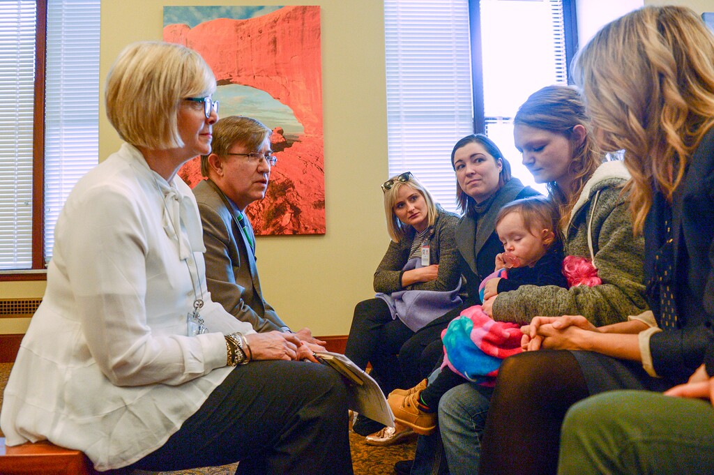 (Leah Hogsten | The Salt Lake Tribune) l-r Rep. Rebecca Edwards, R-North Salt Lake, and Rep. Joel Briscoe, D-Salt Lake City, talk with Alexandra Crowley, right, holding her daughter Peitience, 1. Crowley and her husband, who she says has a good paying job, struggle to make ends meet with a $1150/mo. rent in a cramped triplex. "I'm thankful to have a home at least," she said. Affordable housing advocates joined lawmakers, Wednesday, Feb. 28, 2018 to promote three housing-related bills to finance affordable-housing construction. .