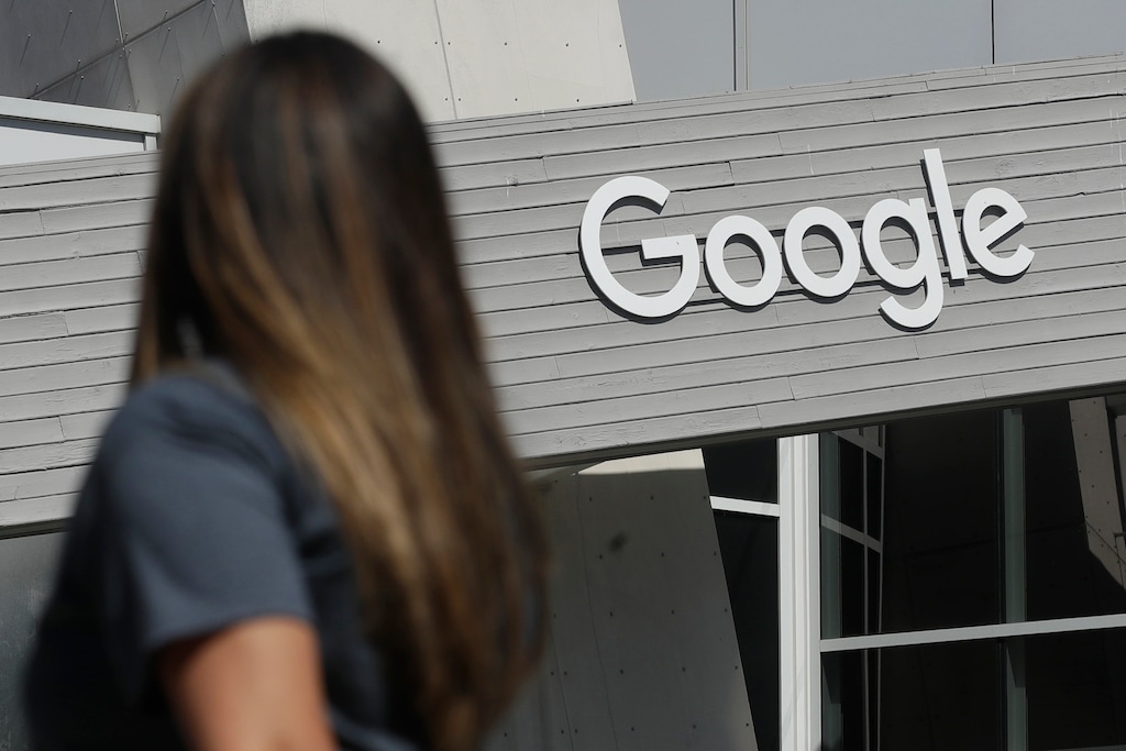 (Jeff Chiu | AP file photo) A woman walks below a Google sign on the campus in Mountain View, Calif., on Sept. 24, 2019.
