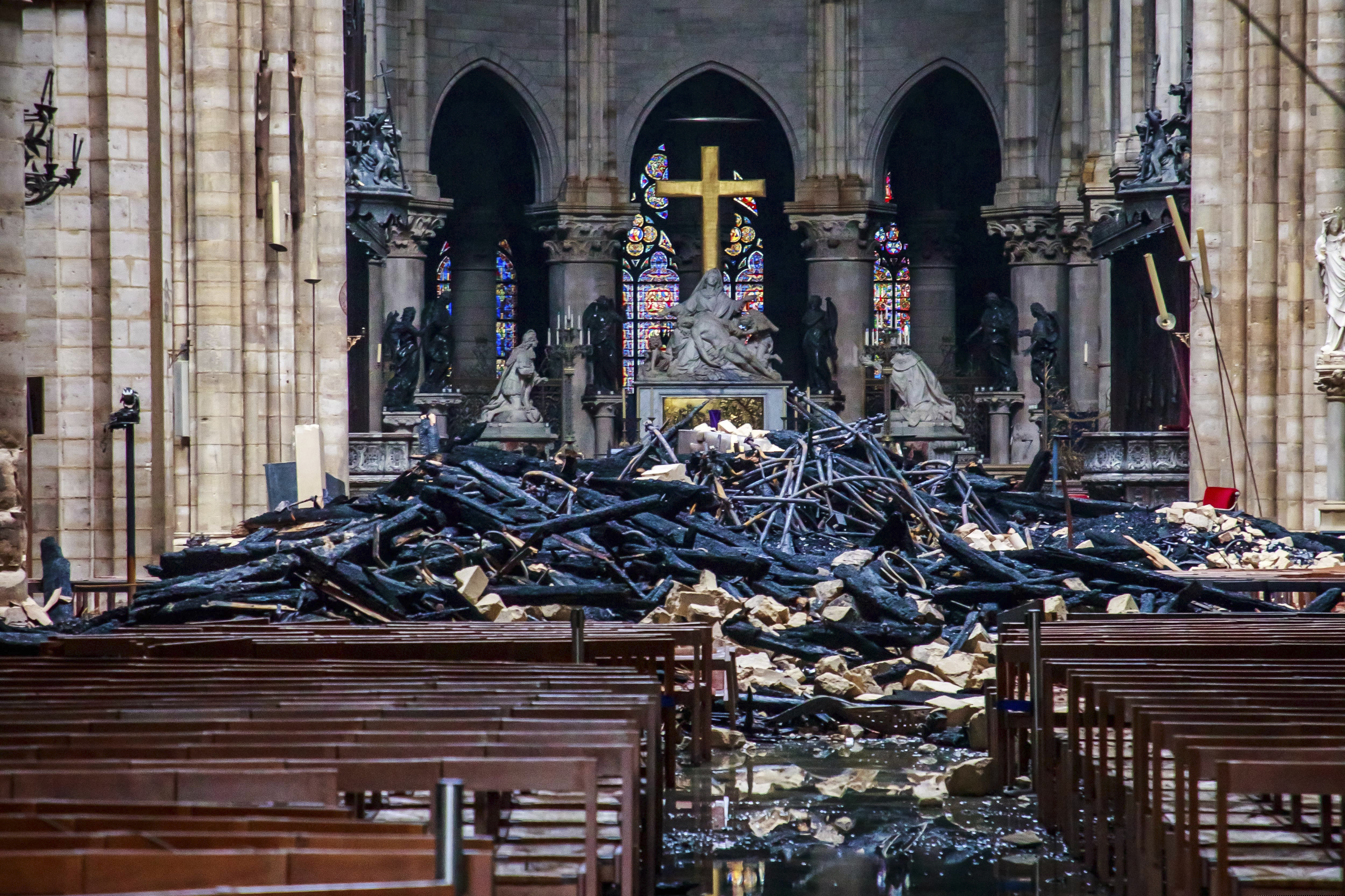 (Christophe Petit Tesson, Pool via AP) A hole is seen in the dome inside Notre Dame cathedral in Paris, Tuesday, April 16, 2019. Firefighters declared success Tuesday in a more than 12-hour battle to extinguish an inferno engulfing Paris' iconic Notre Dame Cathedral that claimed its spire and roof, but spared its bell towers and the purported Crown of Christ.