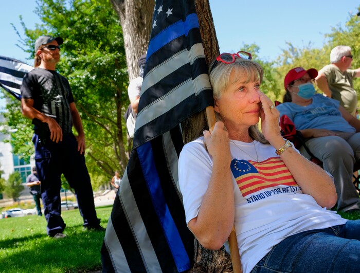 (Leah Hogsten | The Salt Lake Tribune) Vicki Crist wipes tears from her eyes as Heidi Knickerbocker sings a song about an officer who dies in the line of duty at Back the Blue rally in support of law enforcement, Saturday, August 15, 2020 at Washington Square.