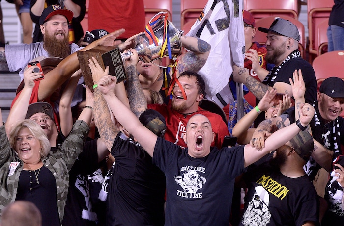 (Leah Hogsten  |  The Salt Lake Tribune) Real Salt Lake fans hoist up the Rocky Mountain Cup with the team. Real Salt Lake defeated the Colorado Rapids 4-1 for the Rocky Mountain Cup at Rio Tinto Stadium, Saturday, August 26, 2017. 