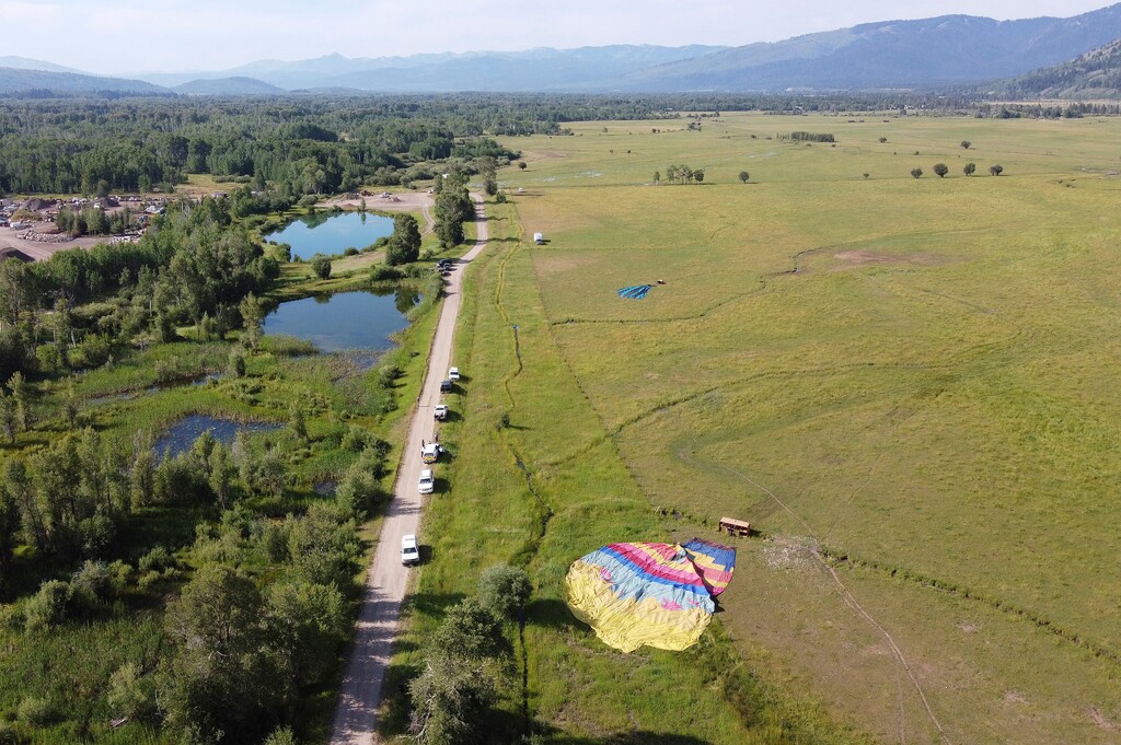 (Brad Boner | Jackson Hole News&Guide via AP) Two of three sightseeing balloons that crashed Monday, Aug. 3, 2020, are seen in an open area of Jackson Hole in western Wyoming. Between 16 and 20 people were hurt, officials said.