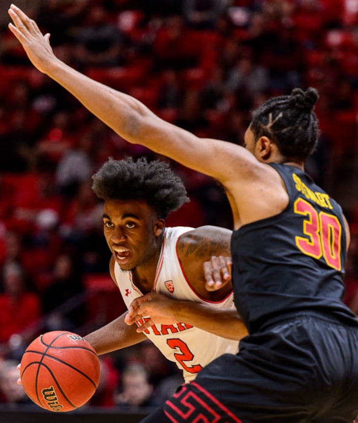 (Trent Nelson | The Salt Lake Tribune)  Utah Utes guard Kolbe Caldwell (2) defended by USC Trojans guard Elijah Stewart (30) as the University of Utah hosts USC, NCAA basketball at the Huntsman Center in Salt Lake City, Saturday Feb. 24, 2018.