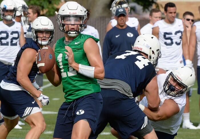 (Francisco Kjolseth  |  The Salt Lake Tribune)  BYU quarterback Zach Wilson runs through drills as the team opens preseason training camp on their practice field on Thursday, Aug. 2, 2018.