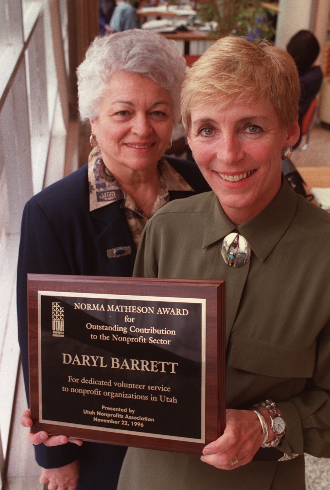 (Lynn Johnson  |  Tribune file photo) In this 1996 photo, Norma Matheson, left, stands with Daryl Barrett after she received the Norma Matheson Award for Outstanding Contribution to the Nonprofit Sector.