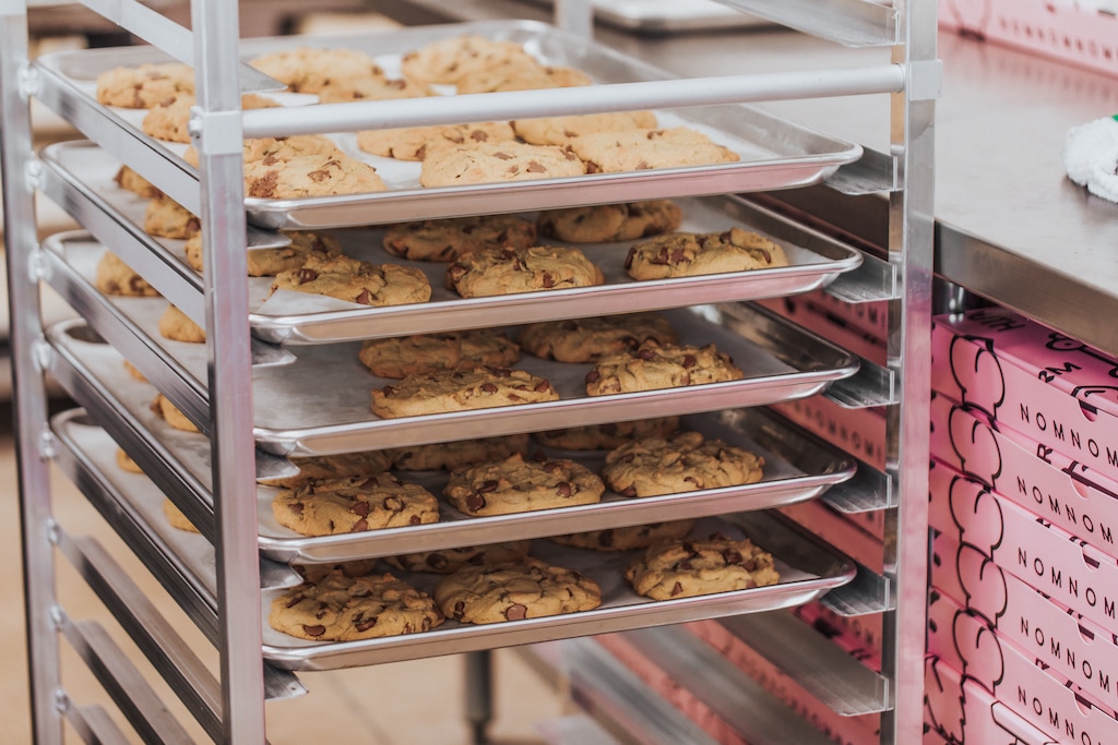 (Crumbl Cookies) Pictured is a cookie tray of Crumbl Cookies. The cousins who founded the Utah-based Crumbl are stepping down from executive roles and day-to-day operations.