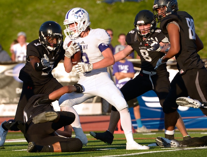 (Leah Hogsten  |  The Salt Lake Tribune) Lehi's Carsen Manookin is surrounded by Alta's defense. Lehi High School leads Alta High School 35-21 at the half during their game, Friday, August 18, 2017 in Sandy. 