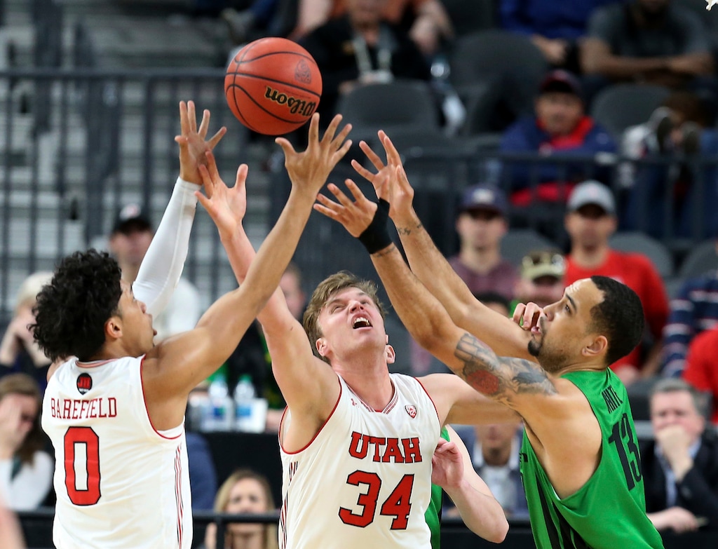 Utah's Sedrick Barefield (0) and Jayce Johnson (34) and Oregon's Paul White (13) reach for a rebound during the first half of an NCAA college basketball game in the quarterfinals of the Pac-12 men's tournament Thursday, March 8, 2018, in Las Vegas. (AP Photo/Isaac Brekken)