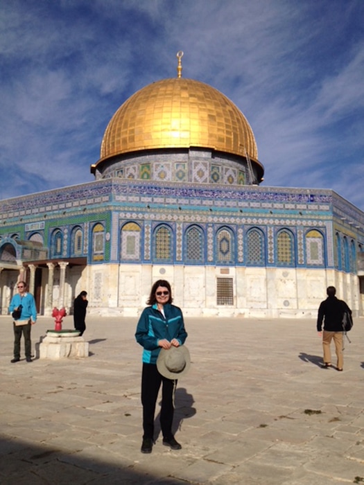(Courtesy Episcopal Diocese of Utah) The Rev. Mary June Nestler, during a recent visit to Jerusalem, stands before the famous Dome of the Rock mosque.