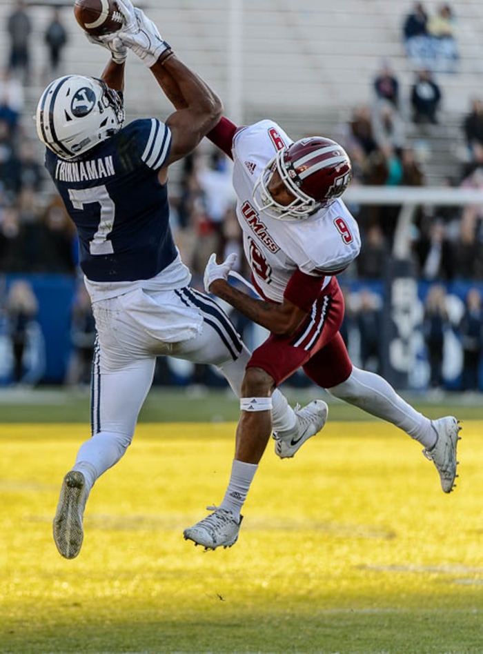 (Trent Nelson | The Salt Lake Tribune)  Brigham Young's Jonah Trinnaman (7) pulls in a pass ahead of Massachusetts Minutemen cornerback Isaiah Rodgers (9) as BYU hosts the University of Massachusetts, NCAA football in Provo, Saturday November 18, 2017.