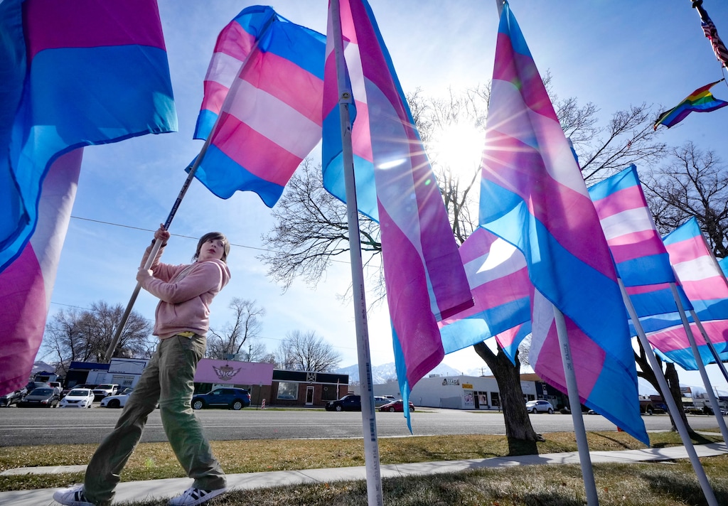 (Francisco Kjolseth | The Salt Lake Tribune) Abby Thornton, 9, helps put up a line of transgender flags in front of the Utah Pride Center in Salt Lake City on Saturday, March 18, 2023, as part of Transgender Day of Visibility on March 31. 