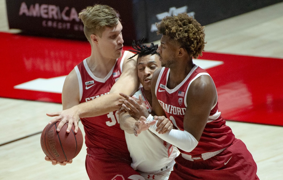 (Francisco Kjolseth  | The Salt Lake Tribune) Utah Utes guard Ian Martinez (2) is squeezed by Stanford Cardinal forward Lukas Kisunas (32), left, and Stanford Cardinal guard Daejon Davis (1) as the Utes host the Stanford Cardinals on Thursday, Jan. 14, 2021 at the Jon M. Huntsman Center in Salt Lake City.