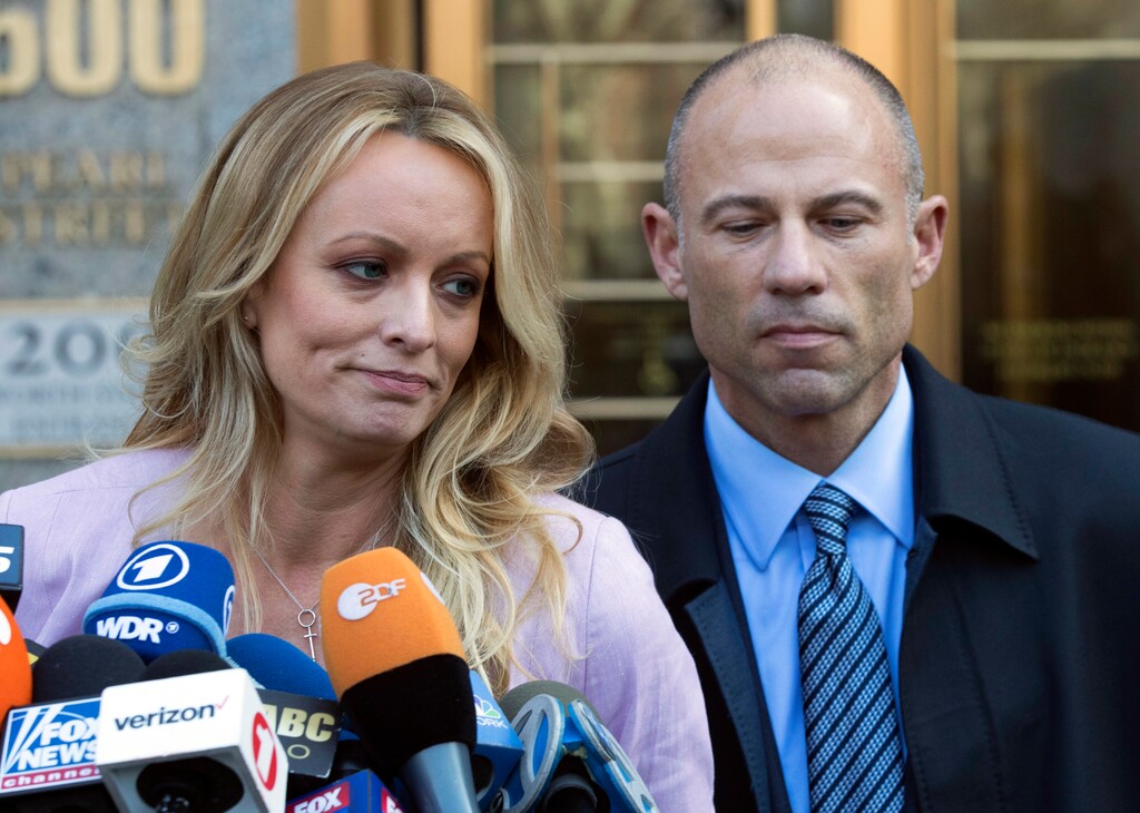 FILE - In this April 16, 2018, file photo, adult film actress Stormy Daniels, left, stands with her lawyer Michael Avenatti as she speaks outside federal court in New York. The story told by President Donald Trump and the White House about payments made to Daniels has evolved over time. The White House has consistently denied Trump had an affair with Daniels, but statements from the president and his aides about a hush money payment made just before the 2016 election have changed. (AP Photo/Mary Altaffer, File)