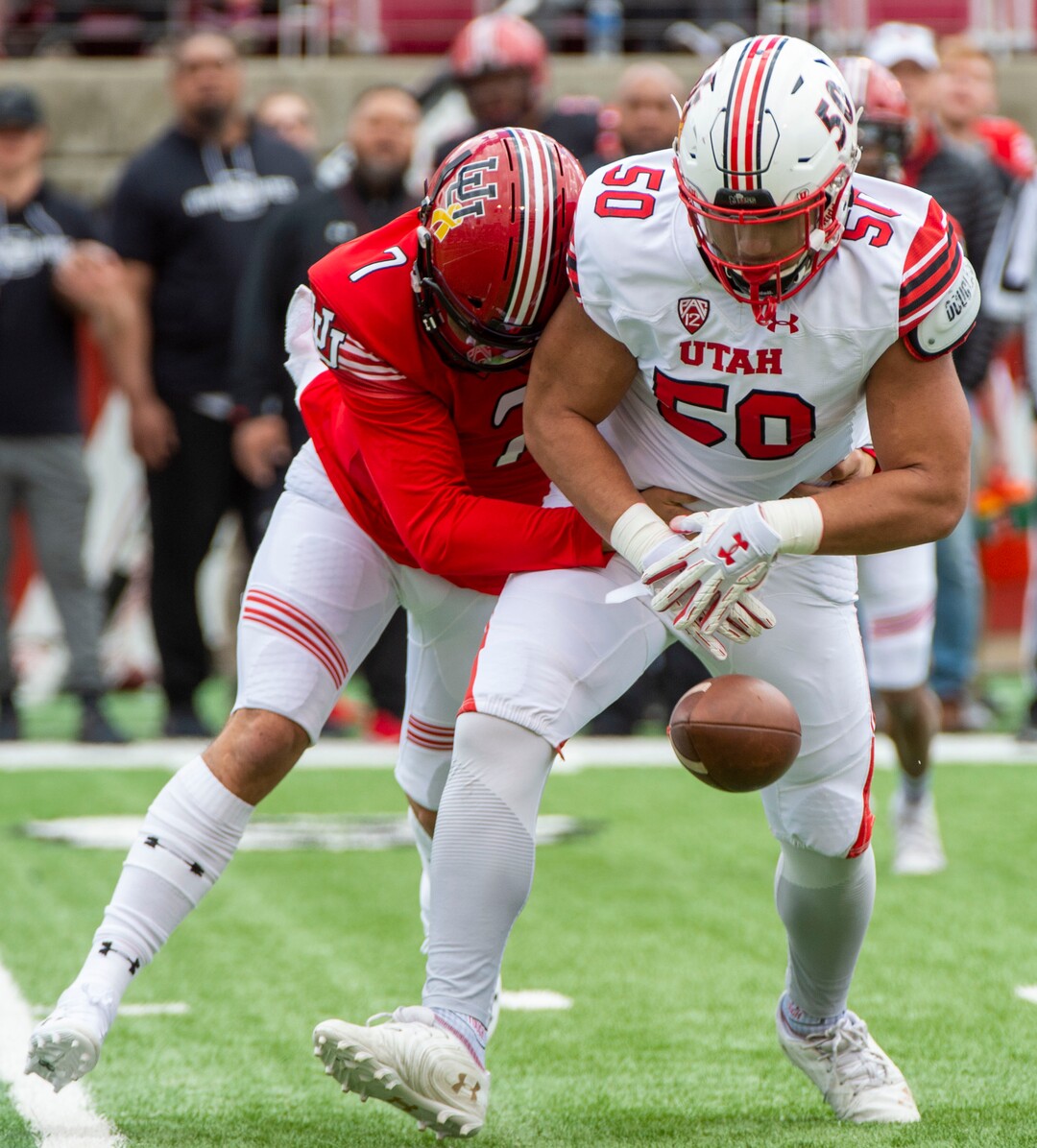 (Rick Egan  |  The Salt Lake Tribune)  Quarterback Cameraon Rising, (7) attempts to wrestle the ball back, after offensive lineman, Orlando Umana pickup his fumble, for a receiver, in Utah's spring Red-White game at Rice-Eccles Stadium, Saturday, April 13, 2019.