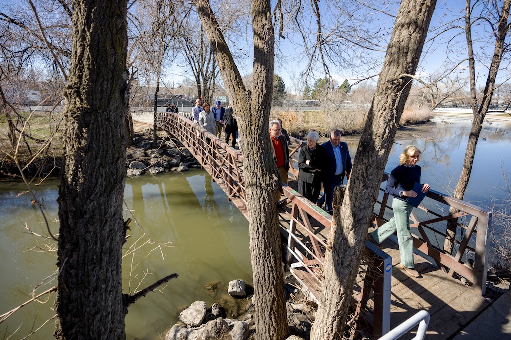 (Trent Nelson | The Salt Lake Tribune) Soren Simonsen, Gail Miller, Amanda Covington and others cross the Jordan River before a news conference about river restoration and improvements, Thursday, Feb. 26, 2026.