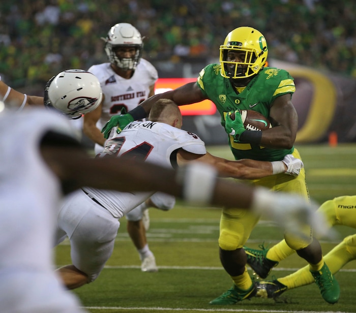 Southern Utah's Mike Needham, left, makes a tackle on Oregon's Royce Freeman, right, as his helmet flies off during the third quarter of an NCAA college football game Saturday, Sept. 2, 2017, in Eugene, Ore. (AP Photo/Chris Pietsch)