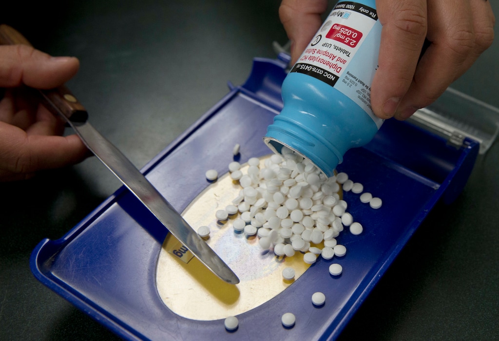 FILE - In this Friday, July 8, 2016, file photo, a pharmacy technician fills a prescription at a pharmacy, in Sacramento, Calif. Lawmakers in almost half the states are considering ways in 2018 to reduce prescription drug costs, including importing them from Canada. (AP Photo/Rich Pedroncelli, File)