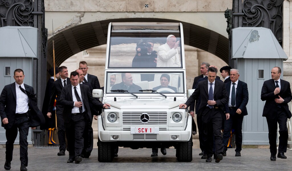 Pope Francis arrives on his popemobile, surrounded by his security guards, for his weekly general audience in St. Peter's Square at the Vatican, Wednesday, March 23, 2016. (AP Photo/Alessandra Tarantino)