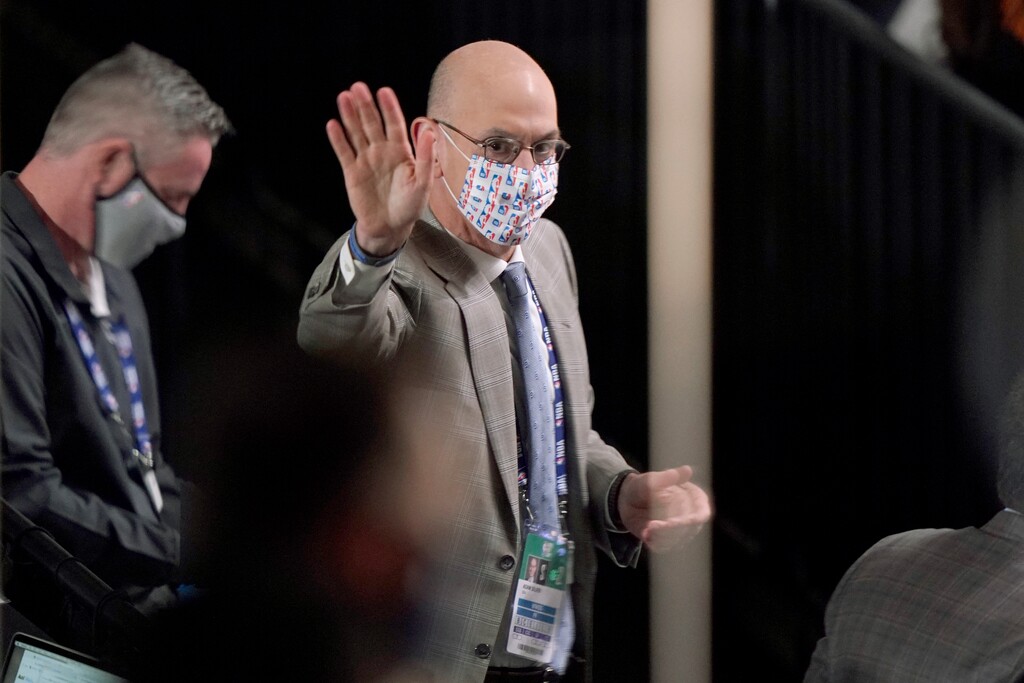 NBA Commissioner Adam Silver waves to Los Angeles Lakers owner Jeanie Buss sitting nearby as he attends Game 2 of basketball's NBA Finals between the Lakers and the Miami Heat on Friday, Oct. 2, 2020, in Lake Buena Vista, Fla. (AP Photo/Mark J. Terrill)