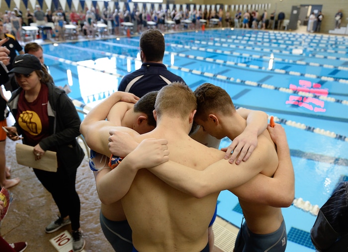 (Francisco Kjolseth  |  The Salt Lake Tribune)  Members of the Mountain Crest swim team embrace for a prayer prior to the start of the high school swimming 4A State Championships in Bountiful, Friday February 9, 2018.