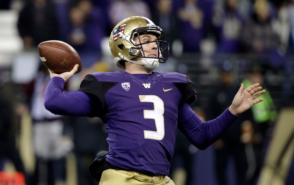 (AP Photo/Elaine Thompson) Washington quarterback Jake Browning launches a pass against Utah during the first half of an NCAA college football game Saturday, Nov. 18, 2017, in Seattle.