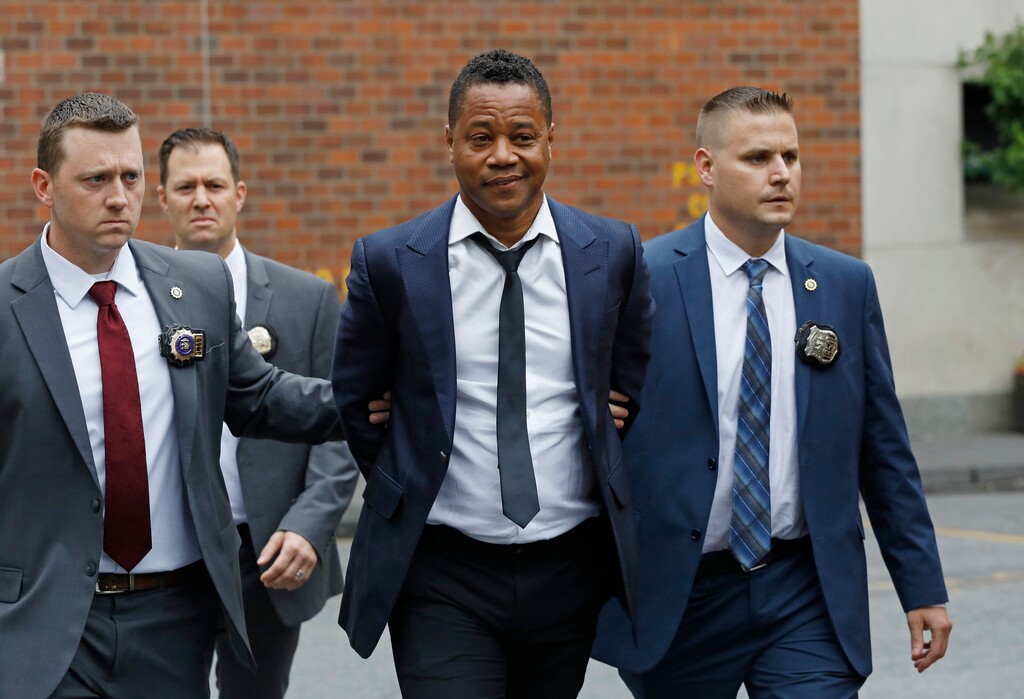 (Mark Lennihan | AP Photo) Actor Cuba Gooding Jr., center, is lead by police officers from the New York Police Department's special victims division, Thursday, June 13, 2019, in New York. Gooding Jr., 51, was arrested Thursday after turning himself in, was charged with forcible touching after a woman accused the actor of groping her at a New York City night spot.