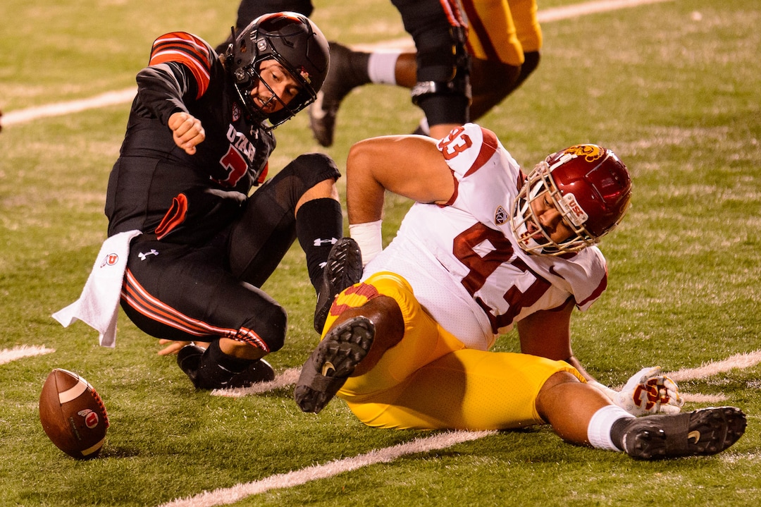 (Trent Nelson  |  The Salt Lake Tribune) Utah Utes quarterback Cameron Rising (7) tries to recover the ball he fumbled as he's hit by USC Trojans defensive lineman Marlon Tuipulotu (93), as the Utah Utes host the USC Trojans, NCAA football at Rice-Eccles Stadium in Salt Lake City on Saturday, Nov. 21, 2020.