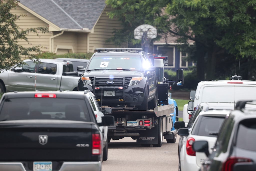 (Tim Gruber | The New York Times) A vehicle believed to belong the suspected gunman, who was impersonating law enforcement is towed away from the home of the late State Rep. Melissa Hortman in Brooklyn Park, Minn., on June 14, 2025. Vance Boelter, the man identified as the suspect in the attacks on two lawmakers, is listed as the director of security patrols on the website of a Minnesota-based security group.