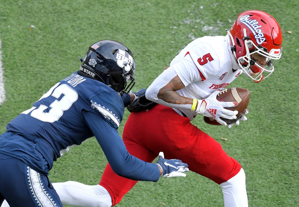 Fresno State wide receiver Jalen Cropper (5) catches a pass as Utah State safety Dominic Tatum (23) defends during the first half of an NCAA college football game, Saturday, Nov. 14, 2020, in Logan, Utah. (Eli Lucero/Herald Journal via AP)