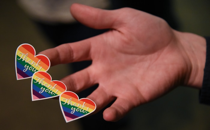 (Francisco Kjolseth  |  The Salt Lake Tribune)  Utah State University volunteers hand out rainbow stickers as they welcome people toe the university's very first drag queen show recently.  