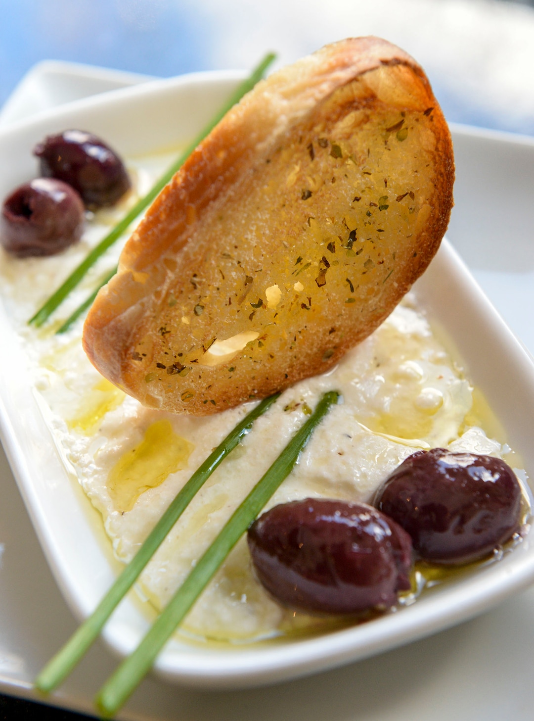 (Leah Hogsten  |  The Salt Lake Tribune) Mama's homemade ricotta served with olives and crostini at Osteria Amore, serving traditional flavors of Italy with a modern spin, Jan. 10, 2020.