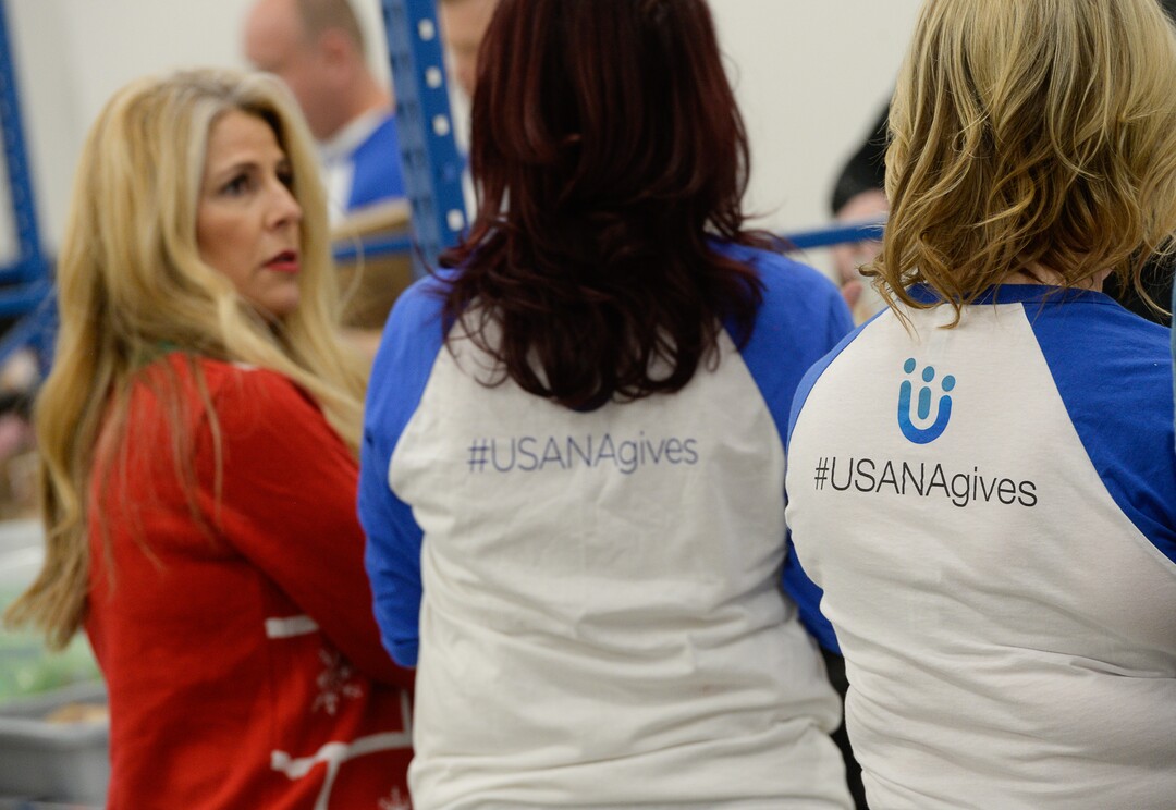 (Francisco Kjolseth  |  The Salt Lake Tribune)  USANA staff volunteer their time assembling food bags for at-risk youth at the newly-renovated packing and storage facility next to the headquarters of the Salt Lake City company on Wed. Dec. 11, 2019. The USANA Foundation has acquired two local charities, Kids Next Door and KidsEat!, that provides hundreds of food bags every week for the kids for the weekends and during long school breaks.
