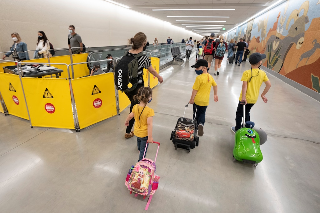 (Rick Egan | The Salt Lake Tribune) Travelers walk through the tunnel to the North Concourse, at the Salt Lake International Airport, on Thursday, June 3, 2021.