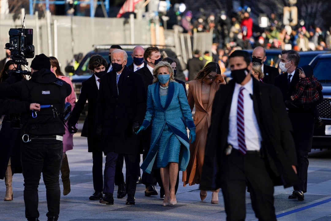 President Joe Biden walks with first lady Jill Biden during the Presidential Escort, part of Inauguration Day ceremonies, Wednesday, Jan. 20, 2021, in Washington. (AP Photo/Evan Vucci)
