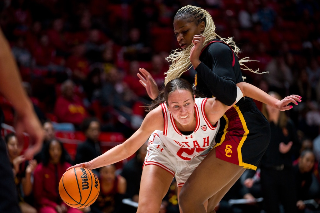 (Trent Nelson  |  The Salt Lake Tribune) Utah Utes forward Jenna Johnson (22) is defended by USC Trojans center Clarice Akunwafo (34) as Utah hosts USC, NCAA basketball in Salt Lake City on Friday, Jan. 19, 2024.