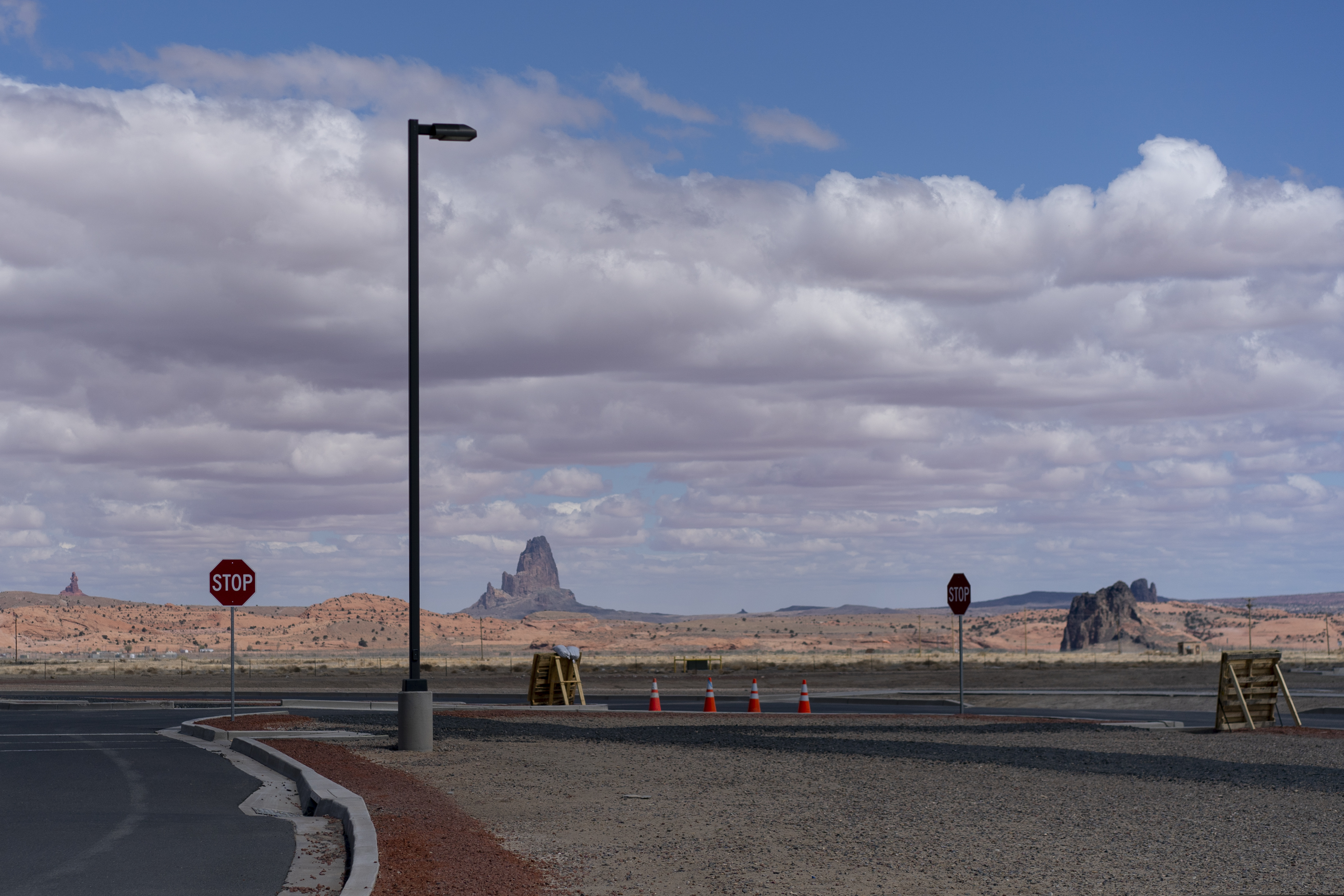 Agathla Peak is seen in the distance beyond the parking lot of Kayenta Health Center on the Navajo reservation in Kayenta, Ariz., on April 18, 2020. The Navajo reservation has some of the highest rates of coronavirus in the country. Team Rubicon is helping with medical operations as cases of COVID-19 surge. (AP Photo/Carolyn Kaster)