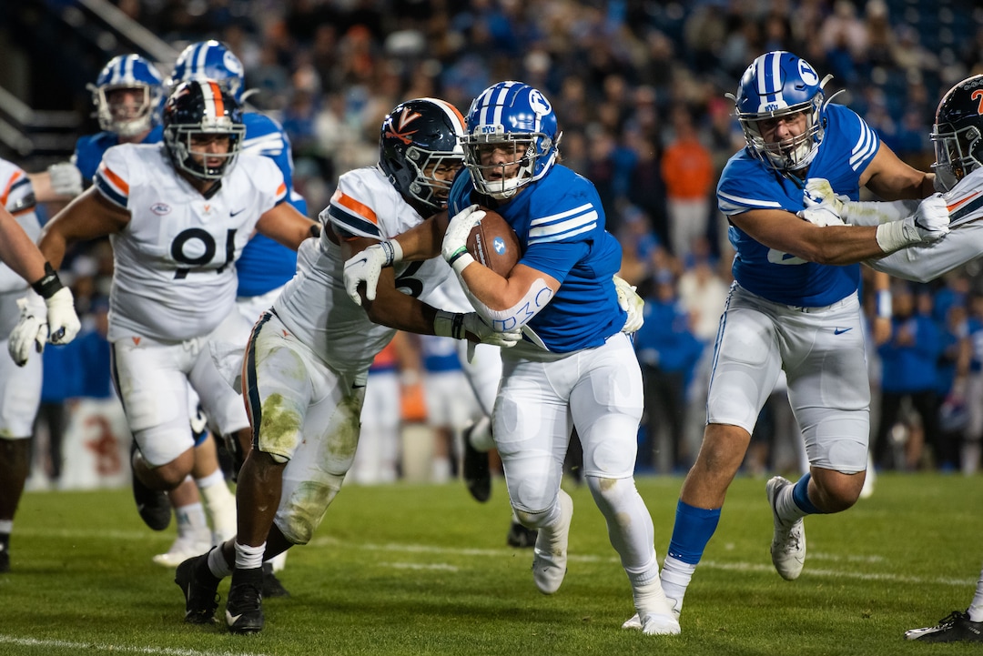 (Trevor Christensen | Special to The Tribune) Brigham Young University's Lopini Katoa is brought down by Virginia's Nick Jackson during the second half at LaVell Edwards Stadium on Saturday, Oct. 30, 2021, in Provo.