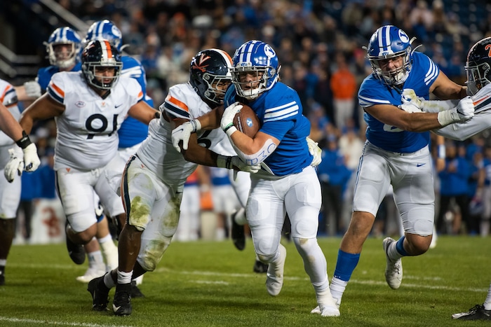 (Trevor Christensen | Special to The Tribune) Brigham Young University's Lopini Katoa is brought down by Virginia's Nick Jackson during the second half at LaVell Edwards Stadium on Saturday, Oct. 30, 2021, in Provo.