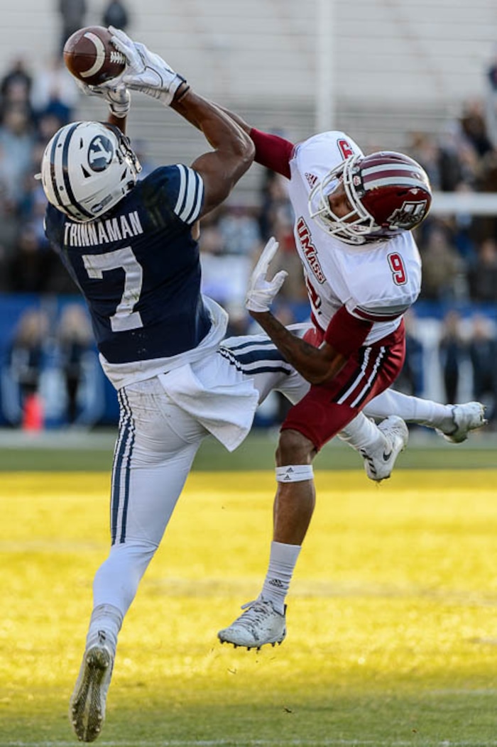 (Trent Nelson | The Salt Lake Tribune)  Brigham Young's Jonah Trinnaman (7) pulls in a pass ahead of Massachusetts Minutemen cornerback Isaiah Rodgers (9) as BYU hosts the University of Massachusetts, NCAA football in Provo, Saturday November 18, 2017.