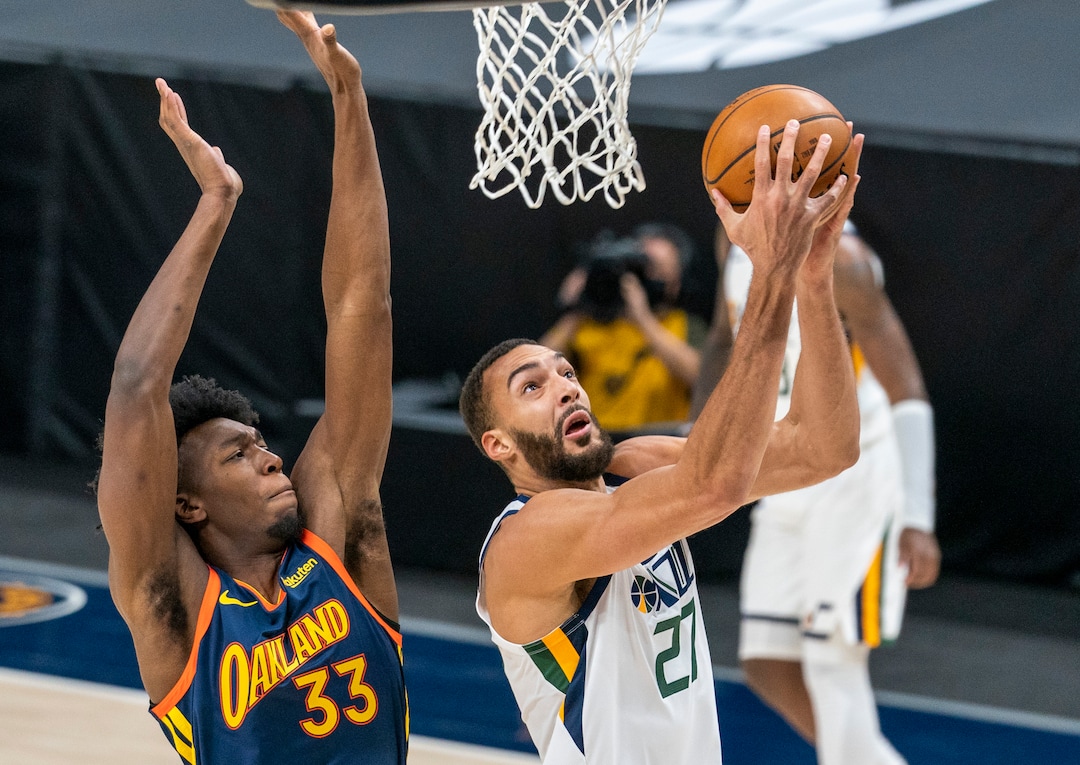 (Rick Egan | The Salt Lake Tribune) Utah Jazz center Rudy Gobert (27) takes the ball to the hoop, as Golden State Warriors center James Wiseman (33) defends, in NBA action between the Utah Jazz and the Golden State Warriors at Vivint Arena, on  Saturday, Jan. 23, 2021.